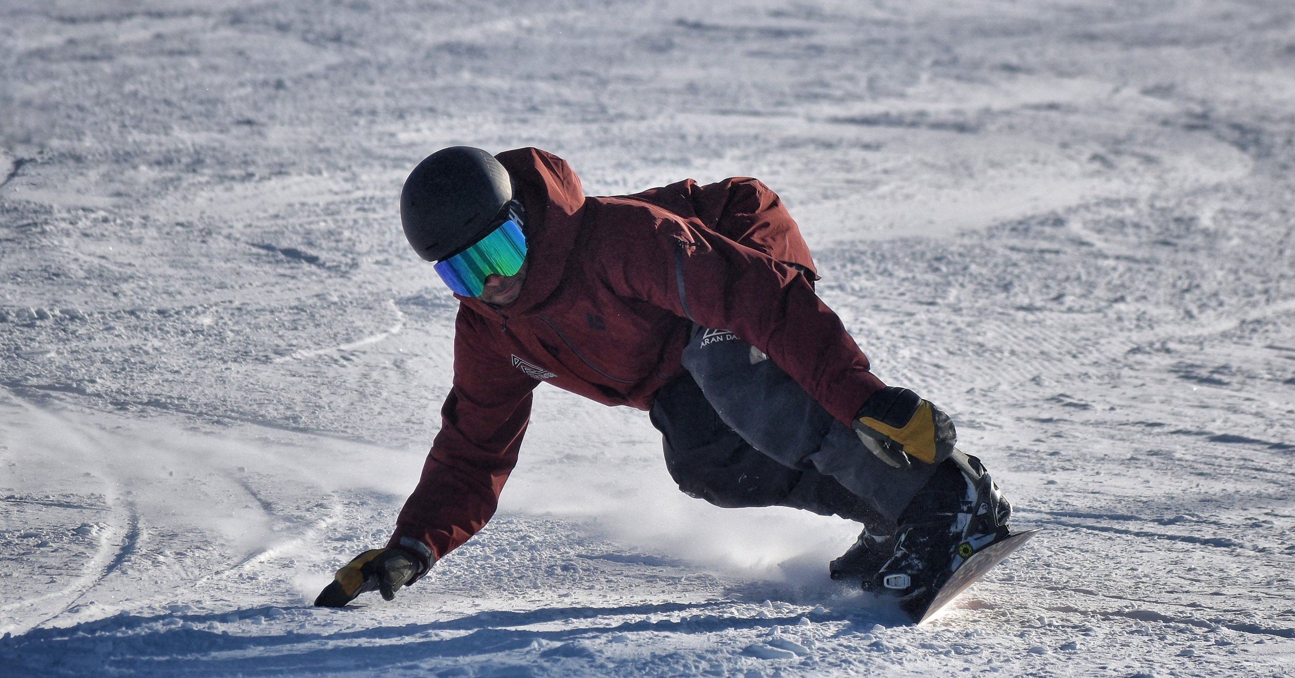 Instructor de Aran Days trazando un giro con snowboard sobre la nieve de Baqueira Beret